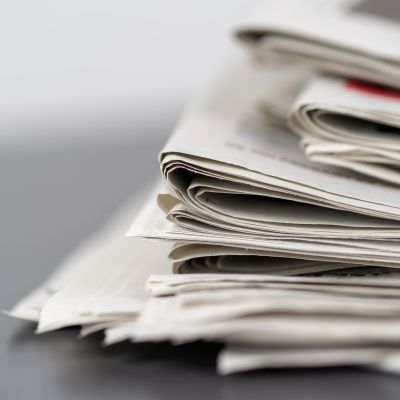 Closeup shot of several newspapers stacked on top of each other